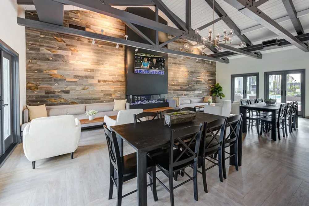 1-BR Apartments In Chatsworth, CA - Waterstone At Chatsworth Apartments - Modern Clubhouse With Tables, Chairs, Couches, Lounge Area, And Fireplace