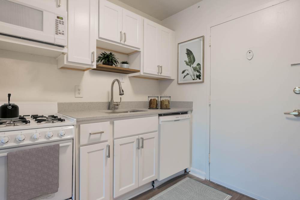 Upgraded kitchen with white cabinetry in a model home at The Towers on Franklin in Richmond, Virginia