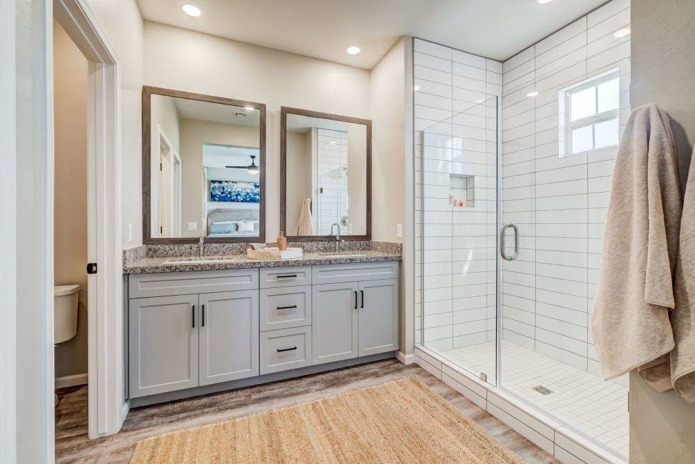 Bathroom with double vanity and large glass shower at BB Living at Trails Edge in Centennial, Colorado