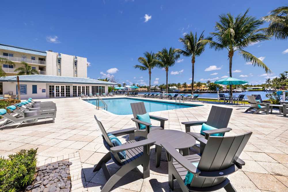 Pool area with tropical palms at Bermuda Cay in Boynton Beach, Florida