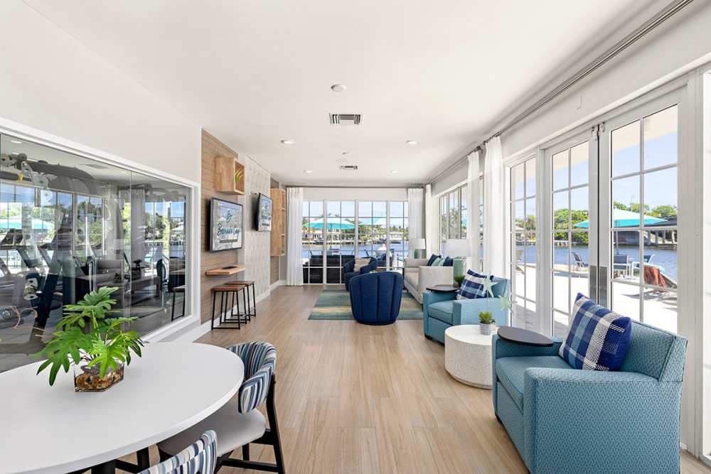 Resident clubhouse with lounge seating and small dining table at Bermuda Cay in Boynton Beach, Florida
