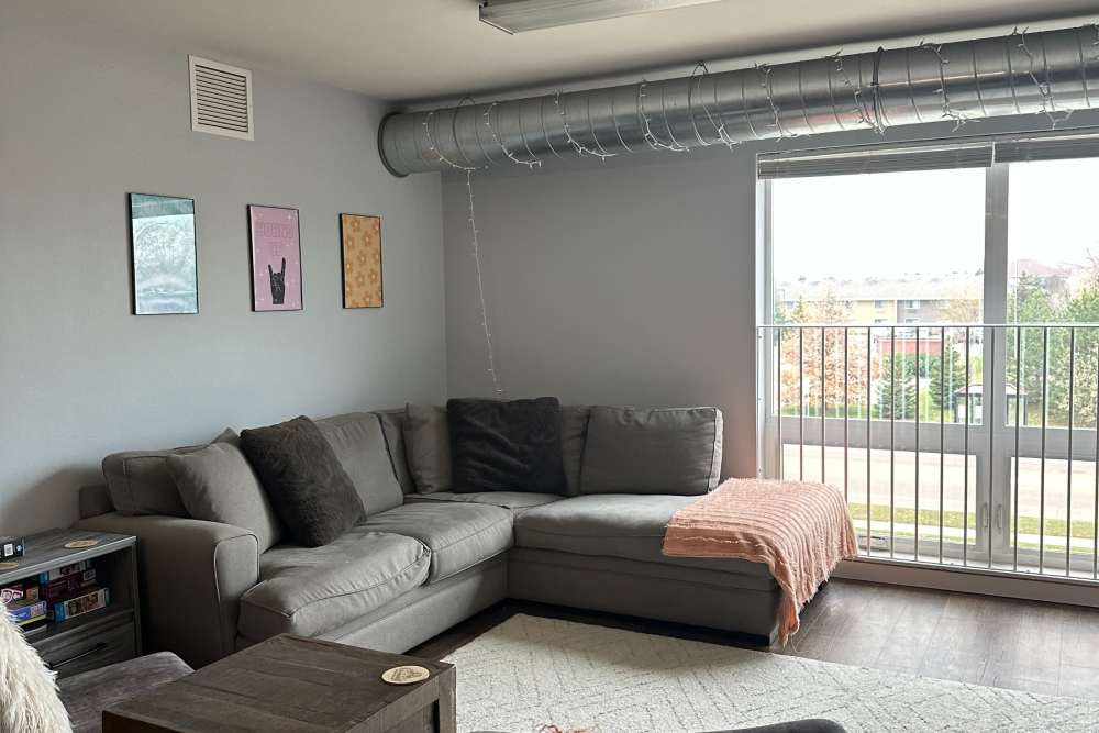 Living room with sectional and hardwood floors at Lofts @ 1633 in Mankato, Minnesota