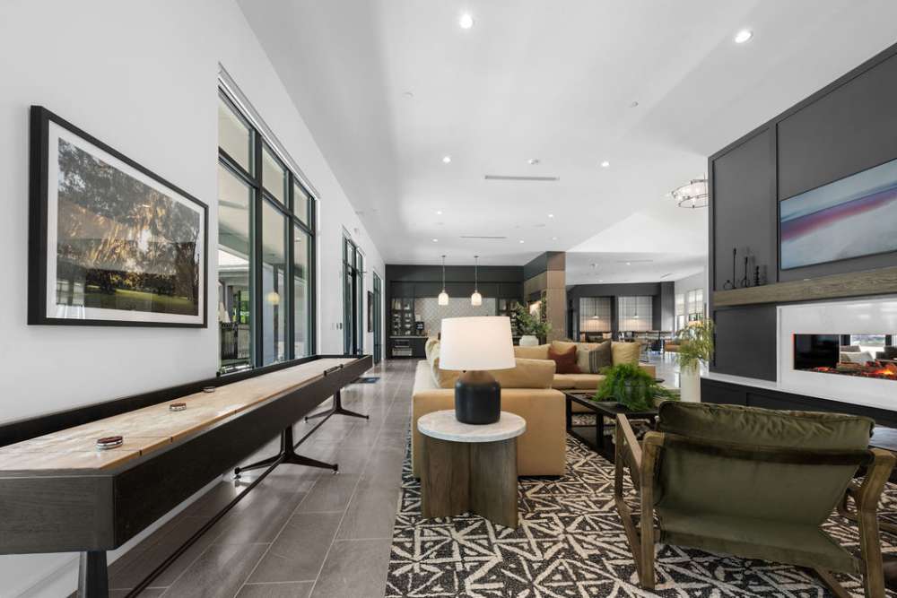 A large dining table next to the kitchen in the community clubhouse at Woodside at Seven Pines in Jacksonville, Florida