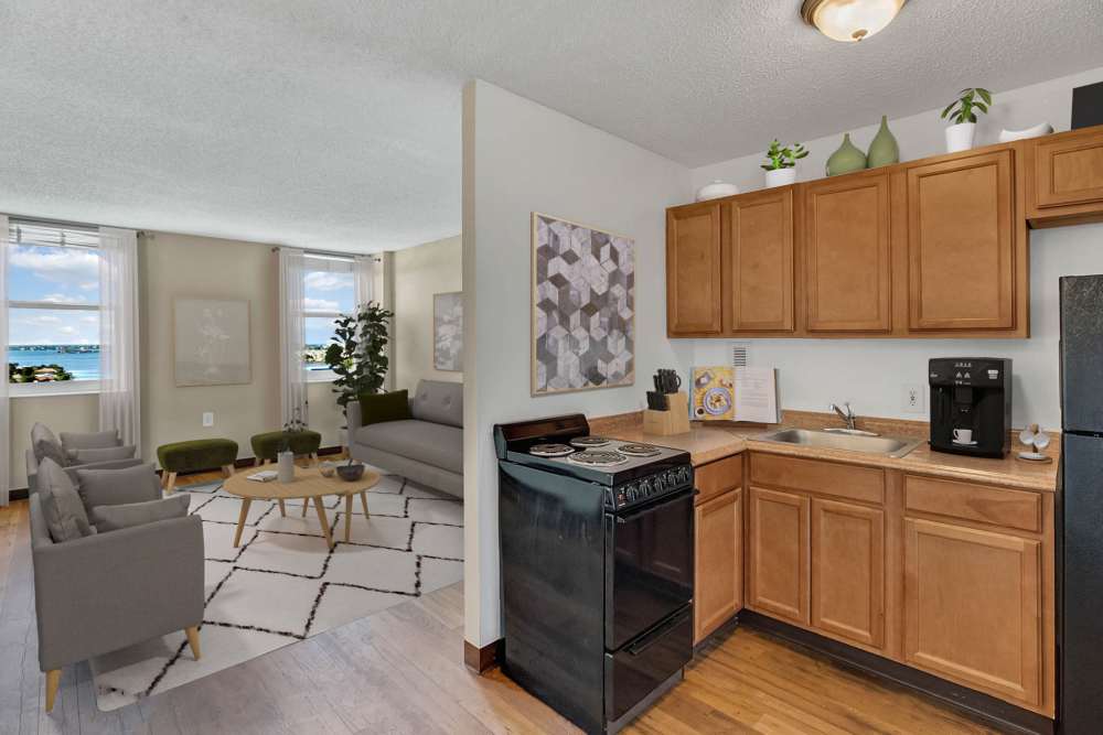 Apartment kitchen with wooden cabinets at Bay Pointe Tower in South Pasadena, Florida