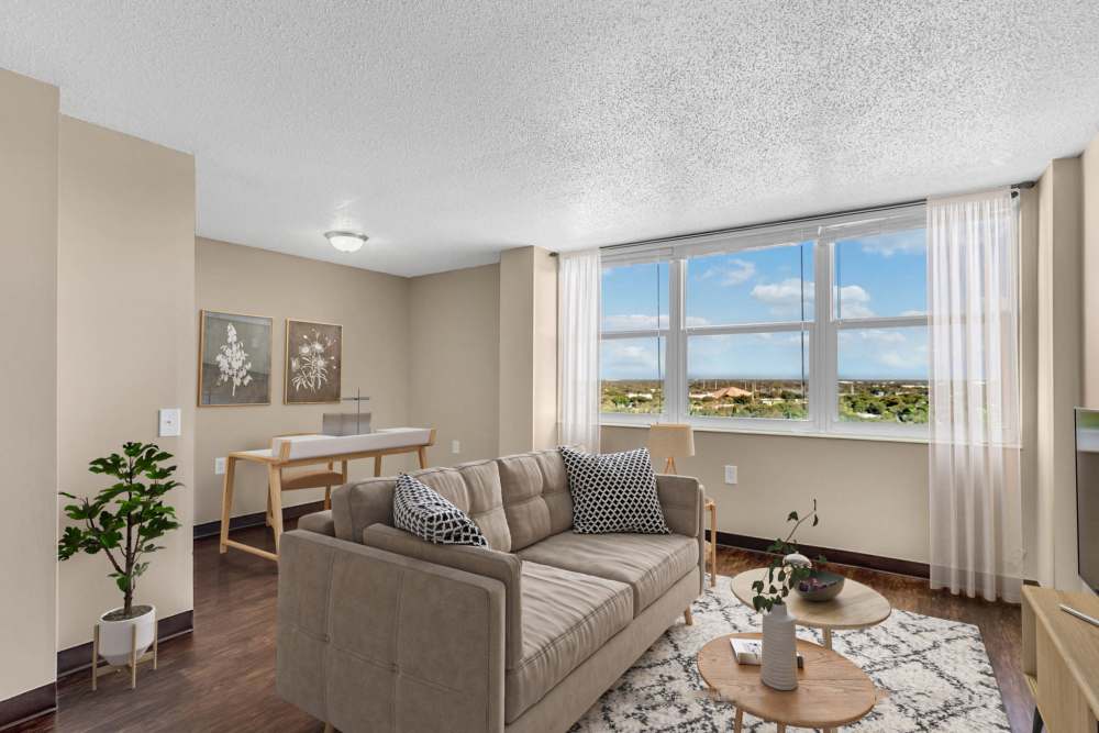 Spacious living room with hardwood flooring and scenic views at Bay Pointe Tower in South Pasadena, Florida