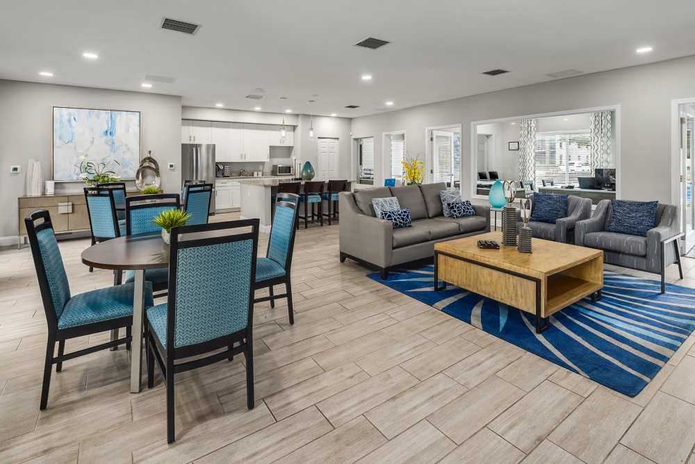 Spacious resident clubhouse with sofa and high-top seating at Boynton Place Apartments in Boynton Beach, Florida