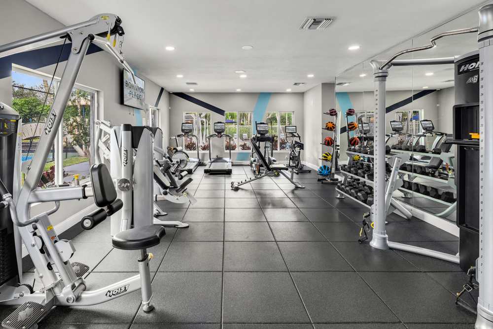 Community gym with weight machines at Boynton Place Apartments in Boynton Beach, Florida