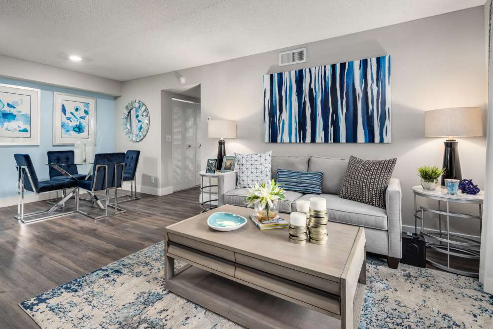 Apartment living room with matching end table lamps, sofa, and coffee table at Boynton Place Apartments in Boynton Beach, Florida