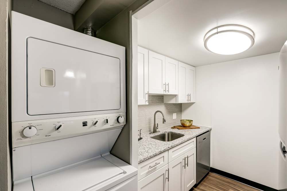 Kitchen with white cabinets and stainless appliances at Park Guilderland Apartments in Guilderland Center, New York