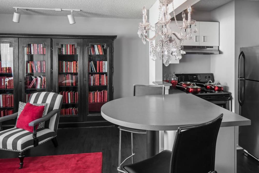 Luxury apartment with dining table and large bookcases at The Gramercy in Manhattan, Kansas