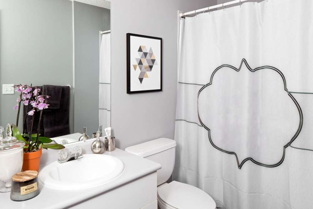 Apartment bathroom with large mirror at The Gramercy in Manhattan, Kansas