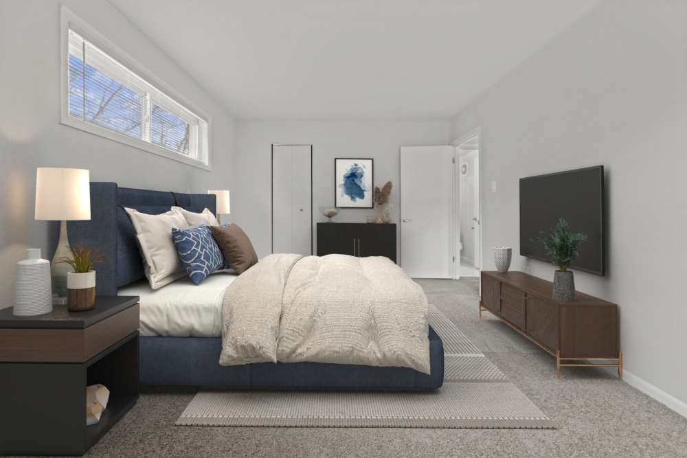 Model bedroom with a large rug at Tysons View in Falls Church, Virginia