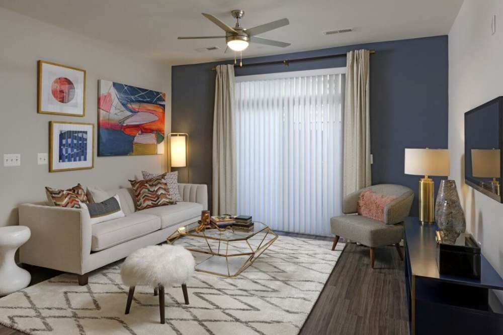 Living room with a blue accent walls at Lync At Alterra in Hyattsville, Maryland