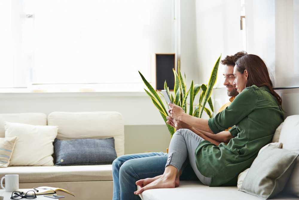 Couple relaxing on their couch in their new home at Shenandoah Commons in Front Royal, Virginia