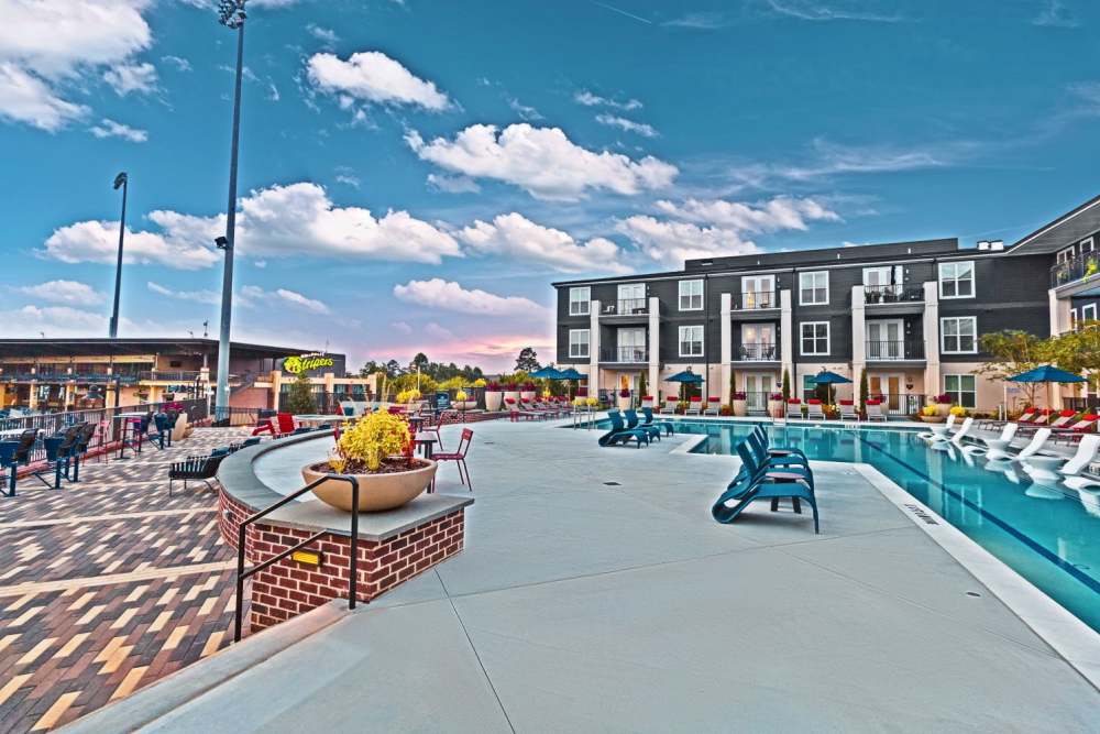 Sparkling salt-water swimming pool and lounge beds at Fieldhouse Apartments in Lawrenceville, Georgia