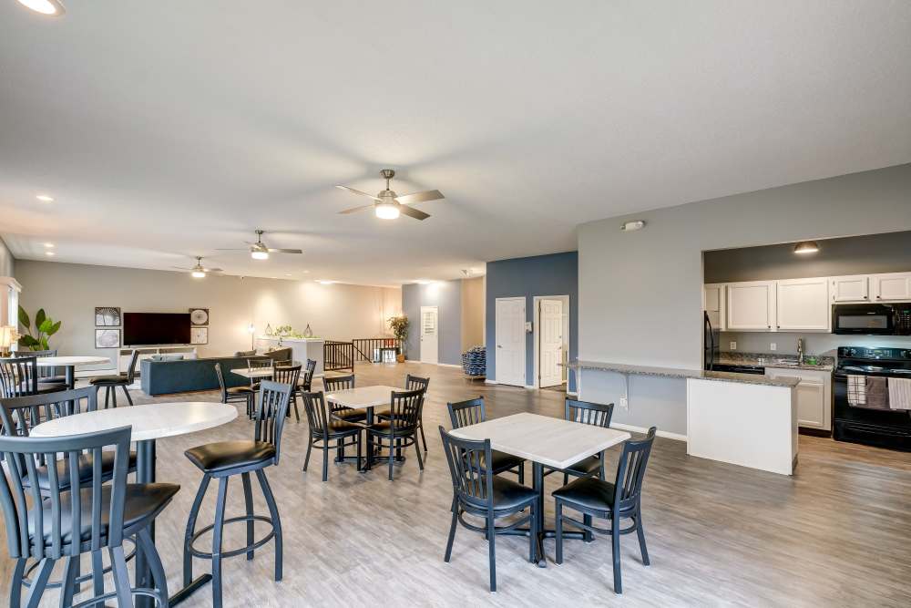 Resident clubroom with lots of tables and a kitchen at Hilton Village II Apartments in Hilton, New York