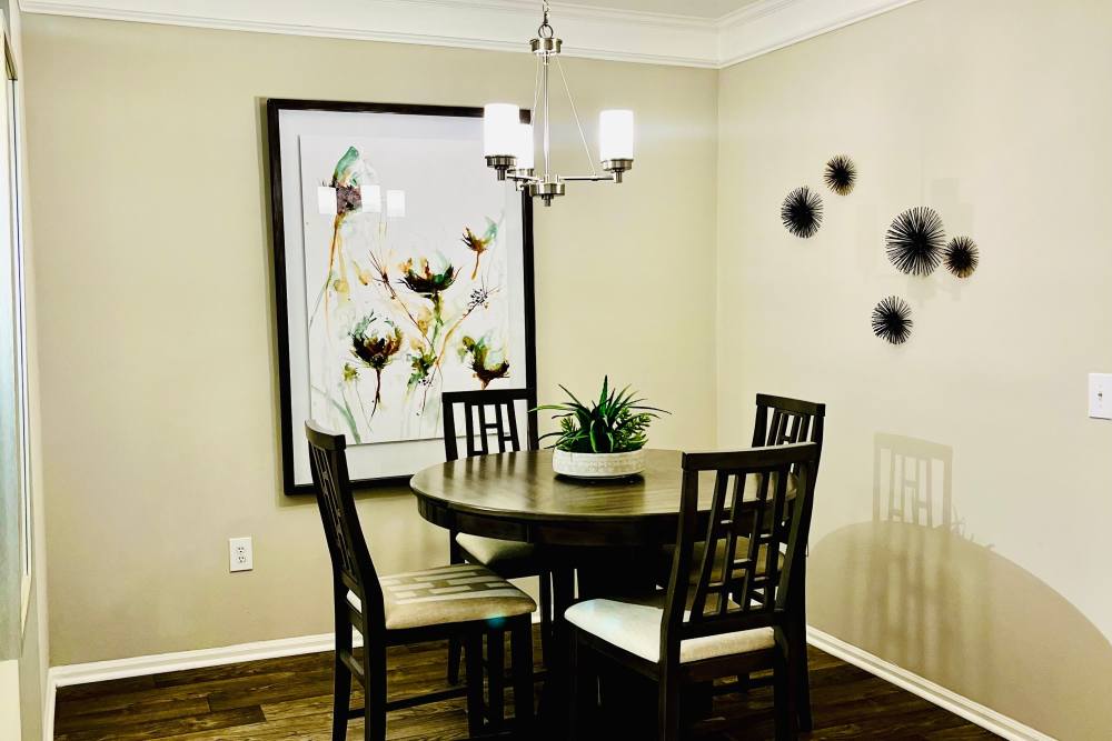 A dining table and chairs in a model apartment at Retreat at Johns Creek in Duluth, Georgia