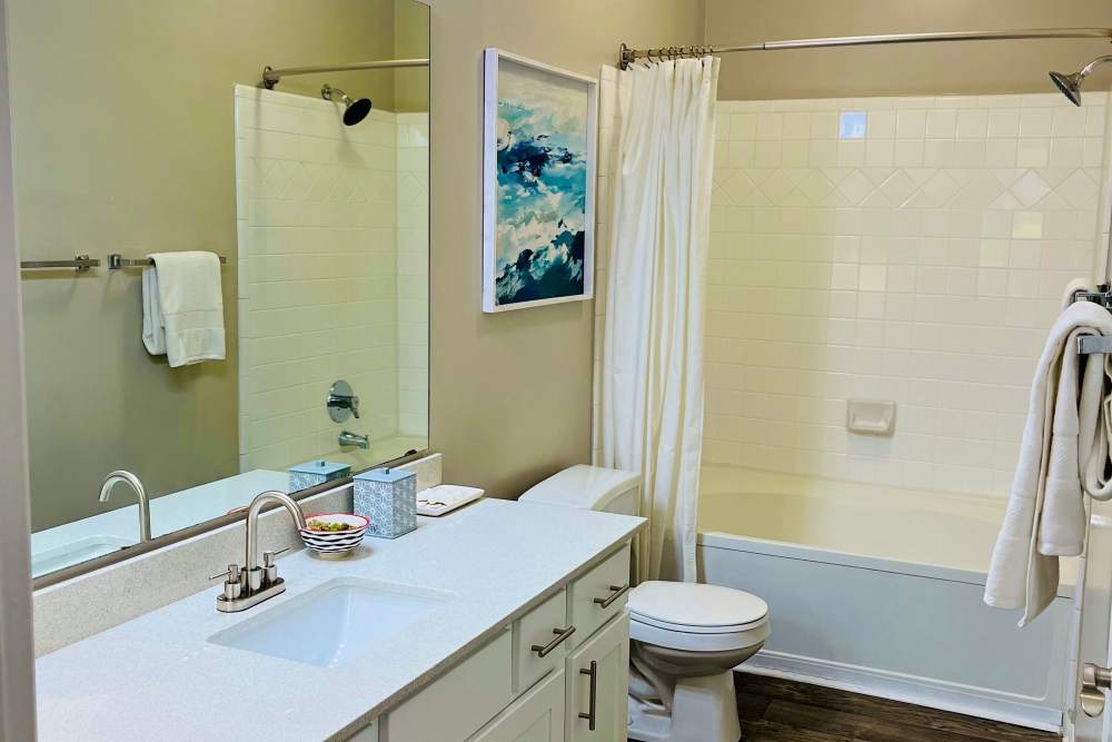 An apartment bathroom with a full-sized bathtub at Retreat at Johns Creek in Duluth, Georgia