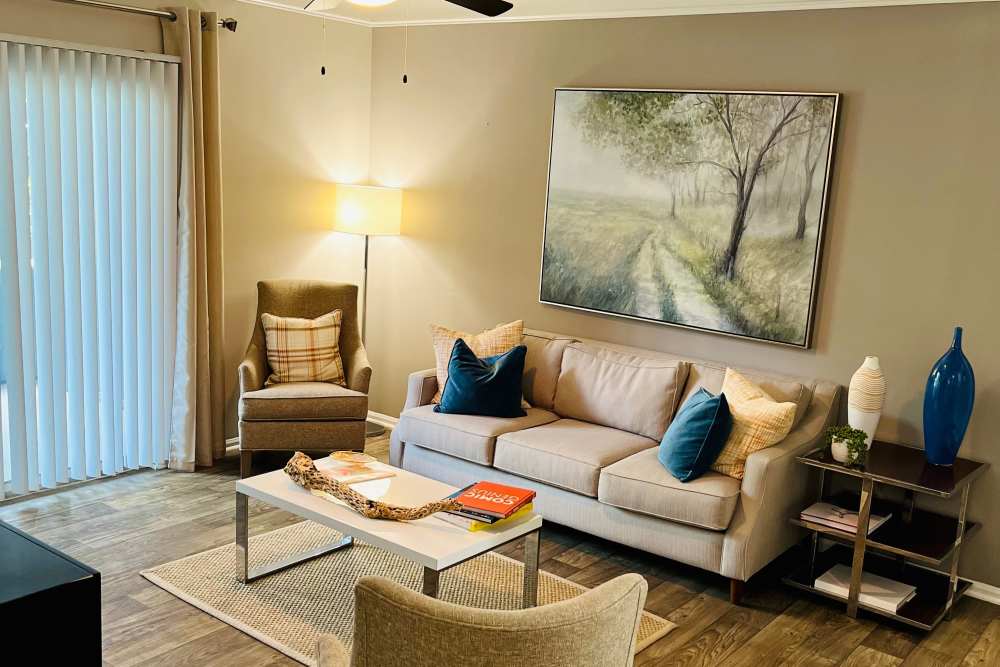 A furnished apartment living room with a sliding door to the patio at Retreat at Johns Creek in Duluth, Georgia