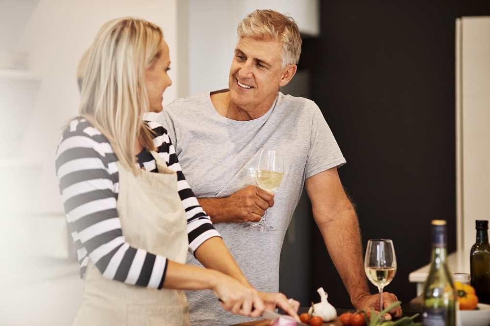 Resident couple preparing dinner in their new home at Evergreen Park Townhomes and Apartments in Lansing, Michigan