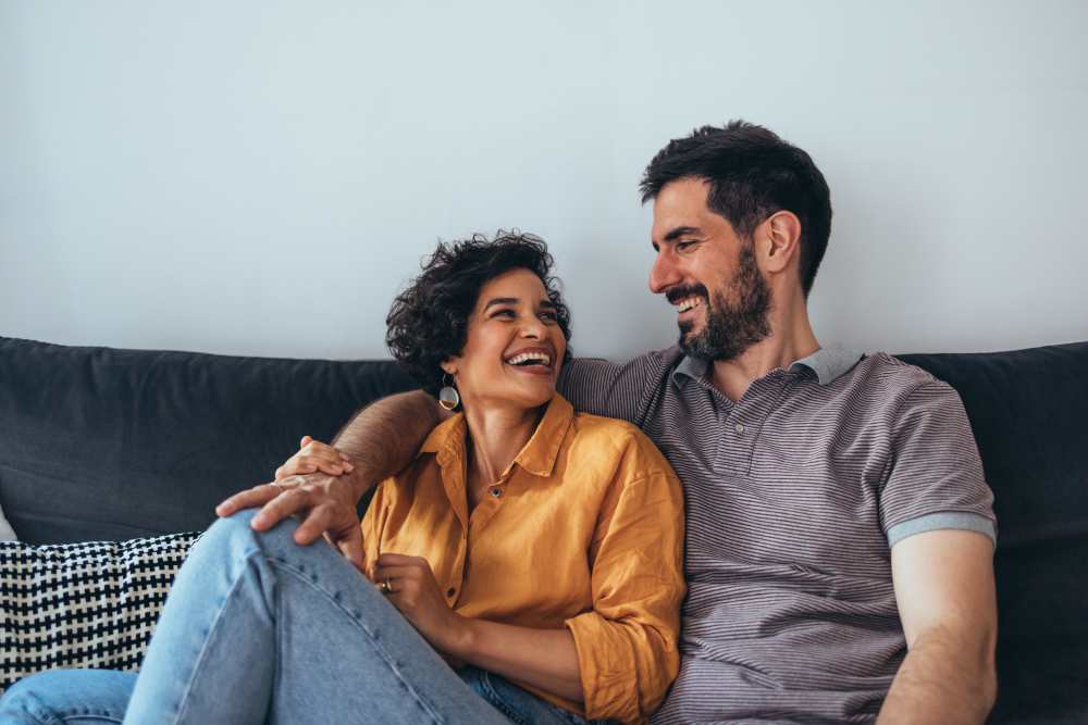 Couple relaxing in their home at Evergreen Park Townhomes and Apartments in Lansing, Michigan