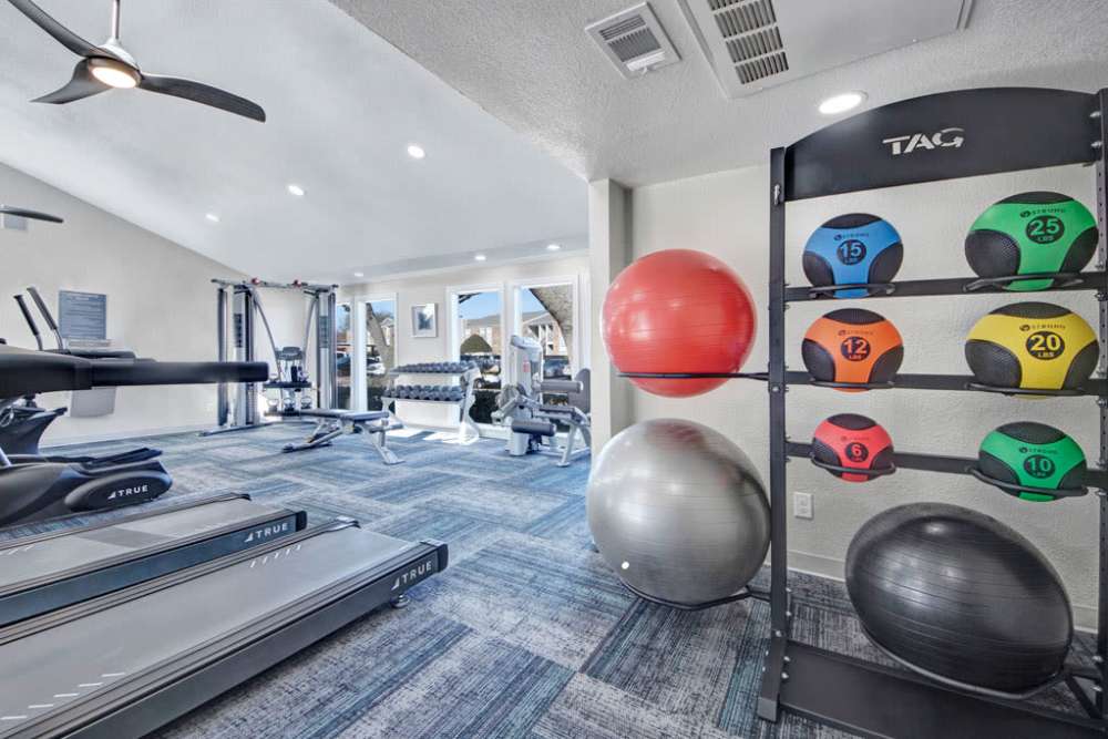 Fitness center with workout gear at The Fairway Apartments in Plano, Texas