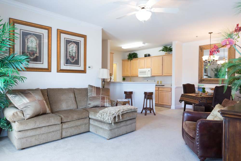 A couch and arm chairs in an apartment living room at Cloisters at Carolina Forest in Myrtle Beach, South Carolina