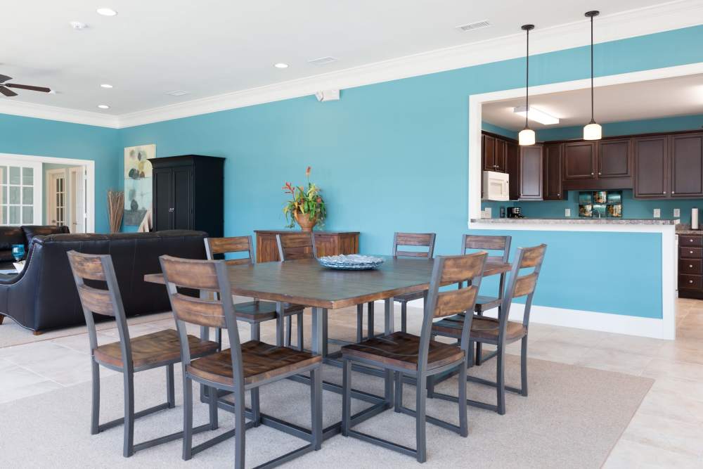 A large table and chairs next to the clubhouse kitchen at Cloisters at Carolina Forest in Myrtle Beach, South Carolina