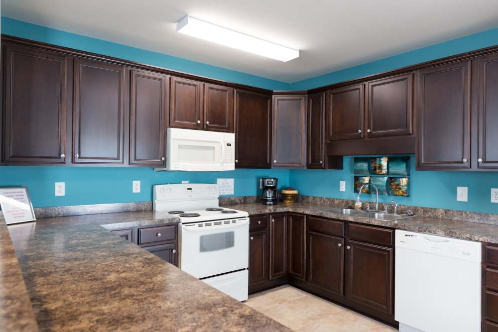 Dark cabinets and white appliances in the clubhouse kitchen at Cloisters at Carolina Forest in Myrtle Beach, South Carolina