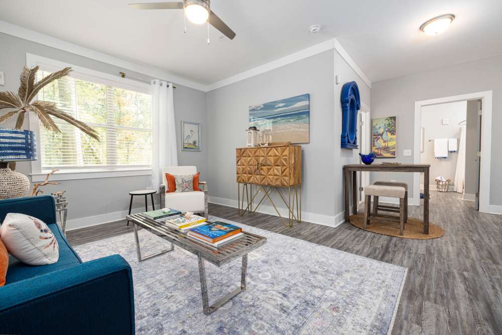 Living room with ceiling fan and wood floors in a model home at Park Circle Village in North Charleston, South Carolina