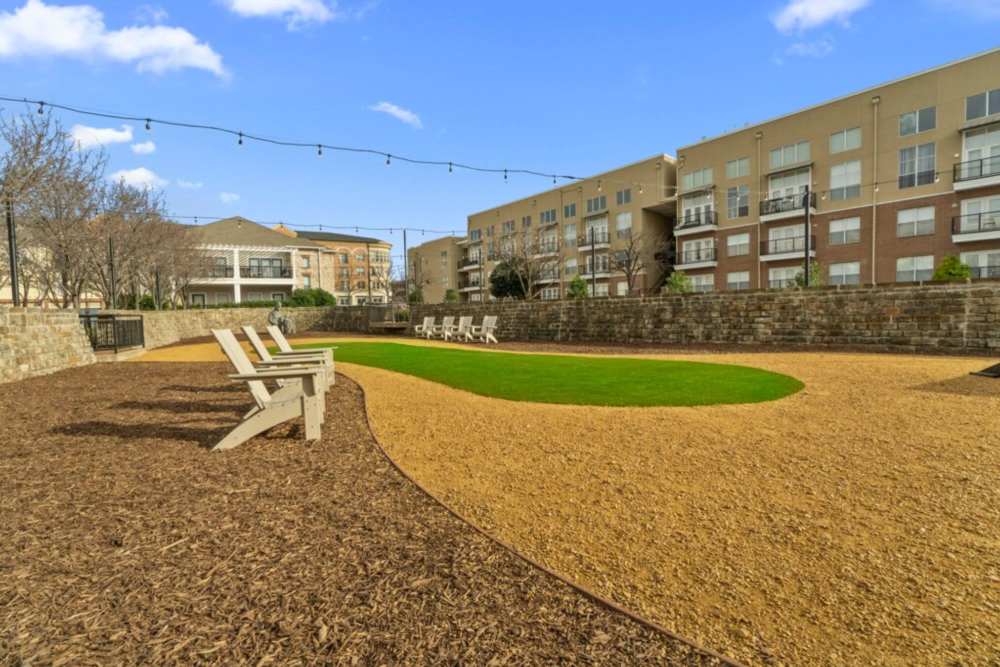 Outdoor area at the park with lush green trees and a winding path at Flatiron District at Austin Ranch, The Colony, Texas