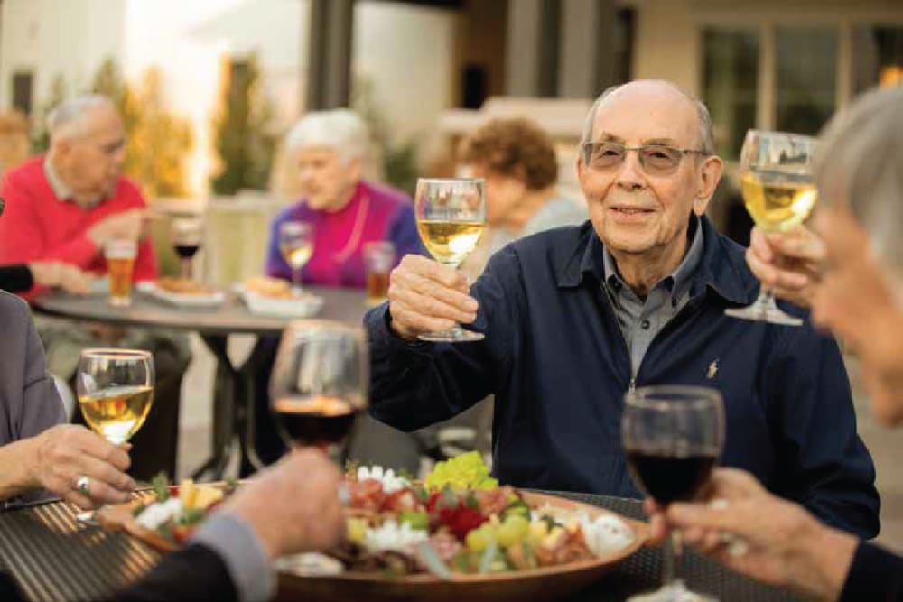 residents raising a glass to a toast at Clearwater at The Heights in Houston, Texas