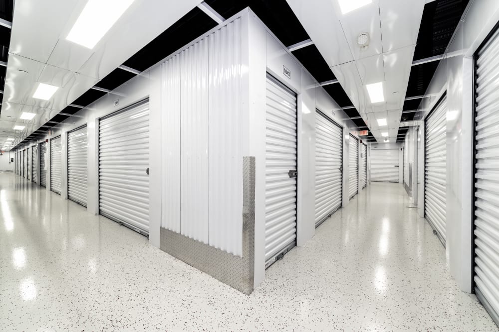 Well-lit hallways between storage units at Your Storage Units Ocoee in Ocoee, Florida