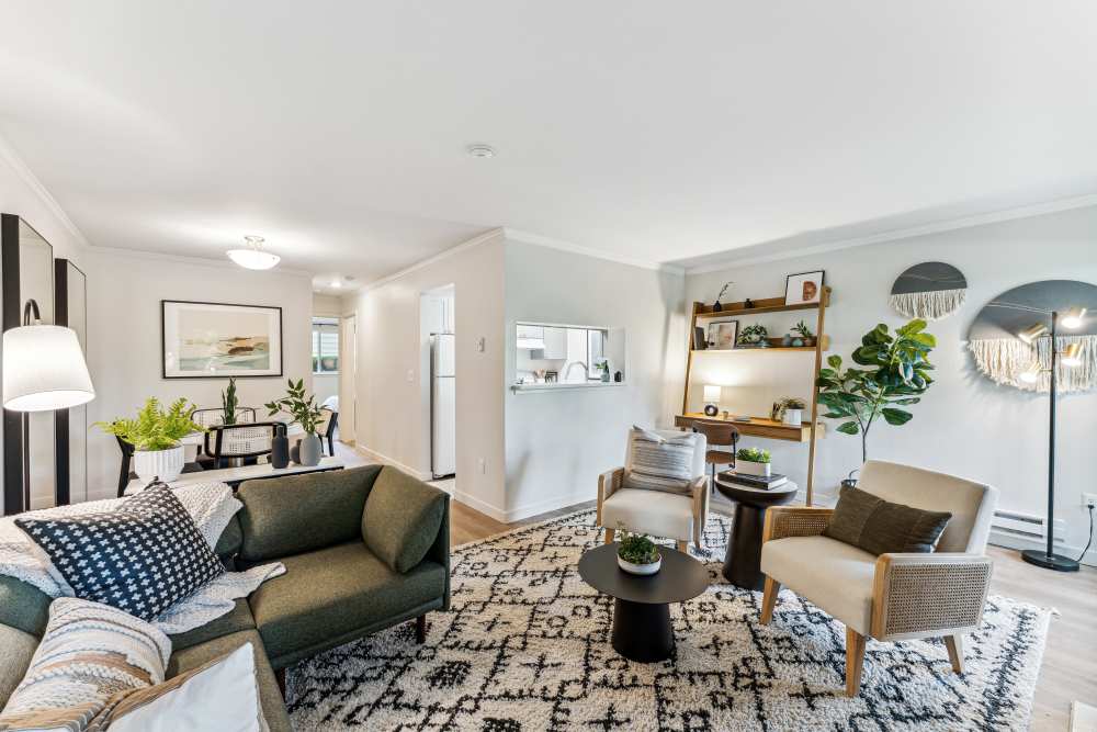 Open concept living, dining, and kitchen areas with hardwood-style flooring at The Knoll Redmond in Redmond, Washington