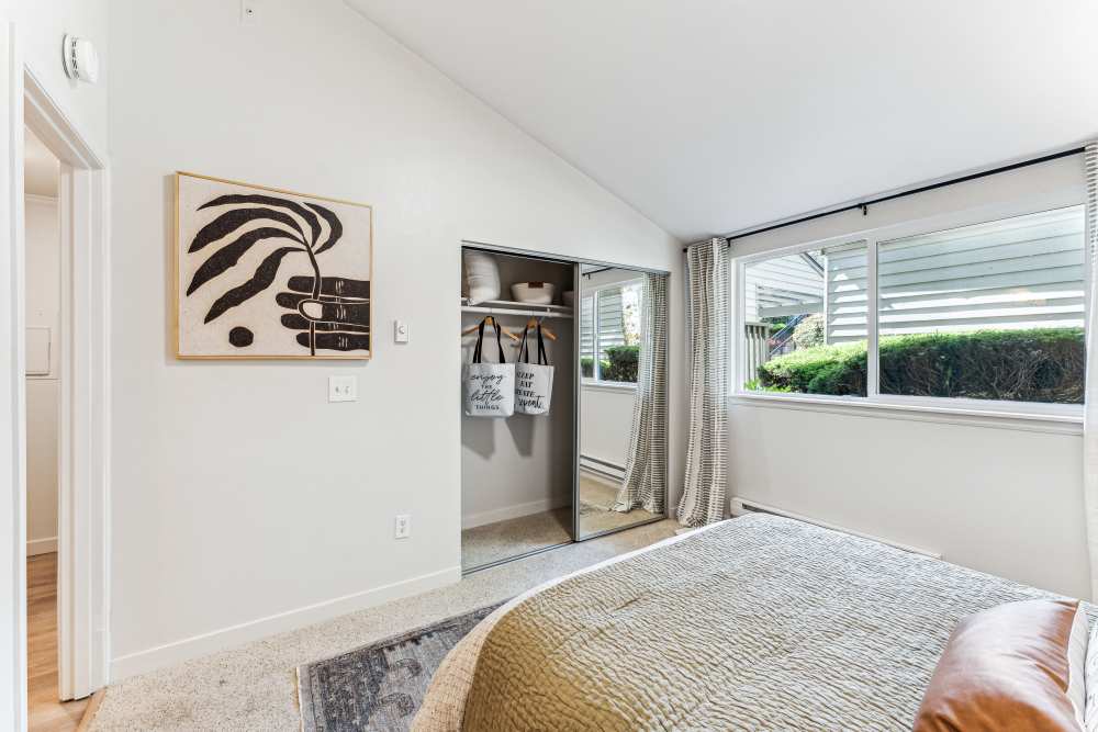 Plush carpeted bedroom with a spacious closet at The Knoll Redmond in Redmond, Washington