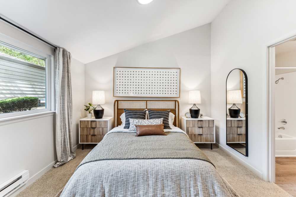 Plush carpeted bedroom with vaulted ceilings and large amounts of natural light at The Knoll Redmond in Redmond, Washington