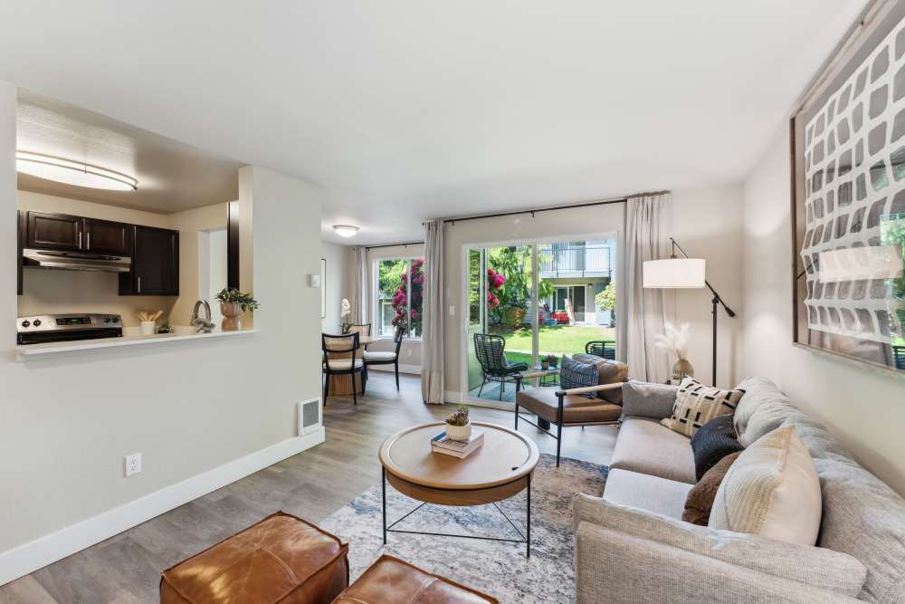 Spacious living area with large windows and large amounts of natural light at Madison Sammamish Apartments in Sammamish, Washington