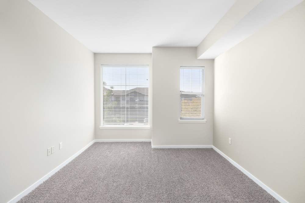 Empty bedroom with two windows at The Greens at Van de Water in Loveland, Colorado