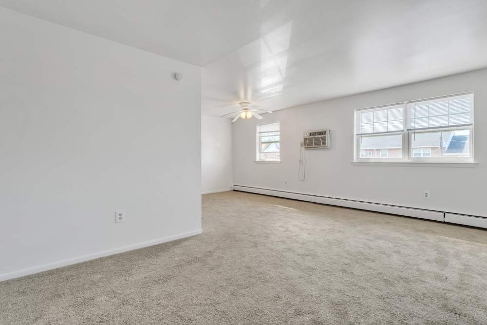 Spacious room with carpet flooring and windows offering natural light at South Mountain Apartment Homes in Allentown, Pennsylvania