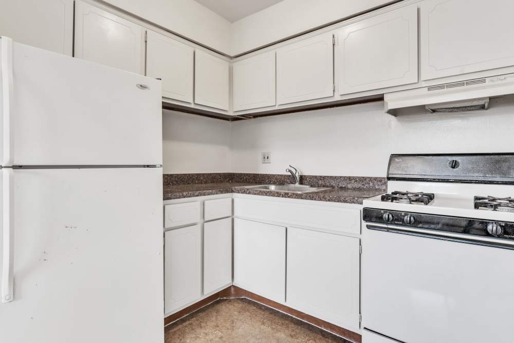 Kitchen with white appliances and white cabinets at South Mountain Apartment Homes in Allentown, Pennsylvania