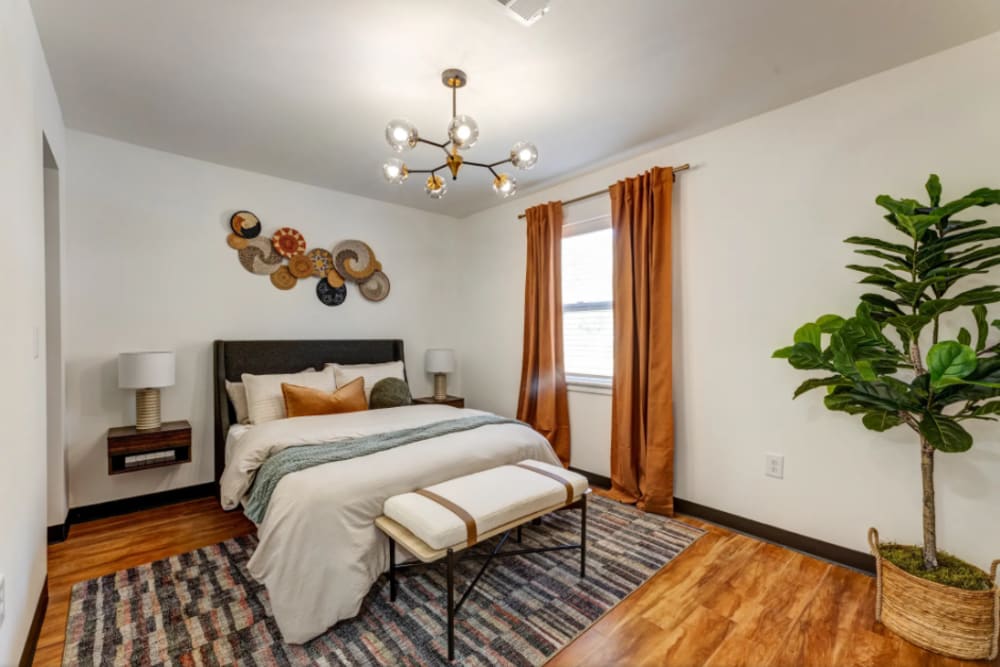 Apartment bedroom with hardwood floors at The Avenue at 3060 in Atlanta, Georgia