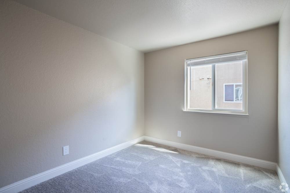 bedroom with large window at Alderwood Park Apartments in Livermore, California