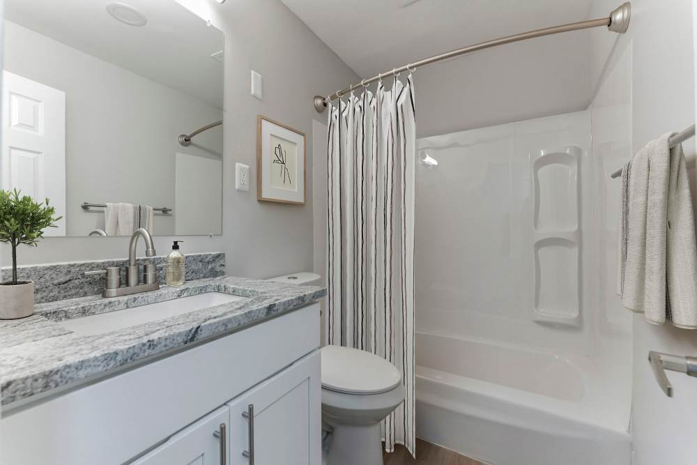 Marble bathroom at Eagle Rock Apartments at Framingham memory care in Framingham, Massachusetts