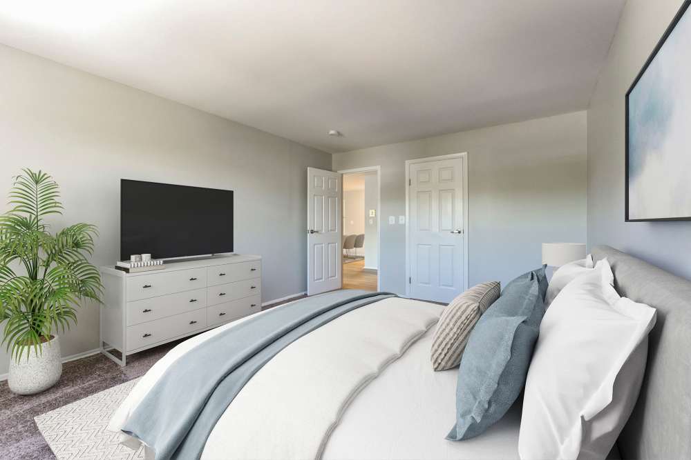 Blue and white Duvet bedroom at Eagle Rock Apartments at Framingham memory care in Framingham, Massachusetts