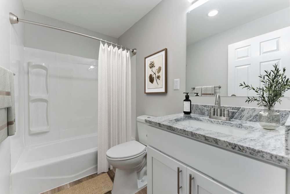 Pristine white bathroom at Eagle Rock Apartments at Framingham memory care in Framingham, Massachusetts