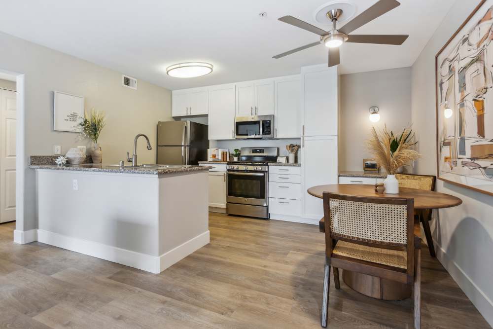 Open concept kitchen and dining area ready for residents to enjoy in a model home at Avery at Moorpark in Moorpark, California