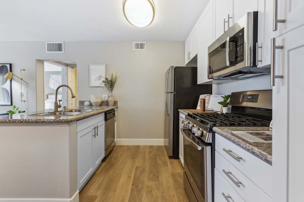 Upgraded and modern kitchen with stainless steel appliances, including a dishwasher and mircrowave at Avery at Moorpark in Moorpark, California