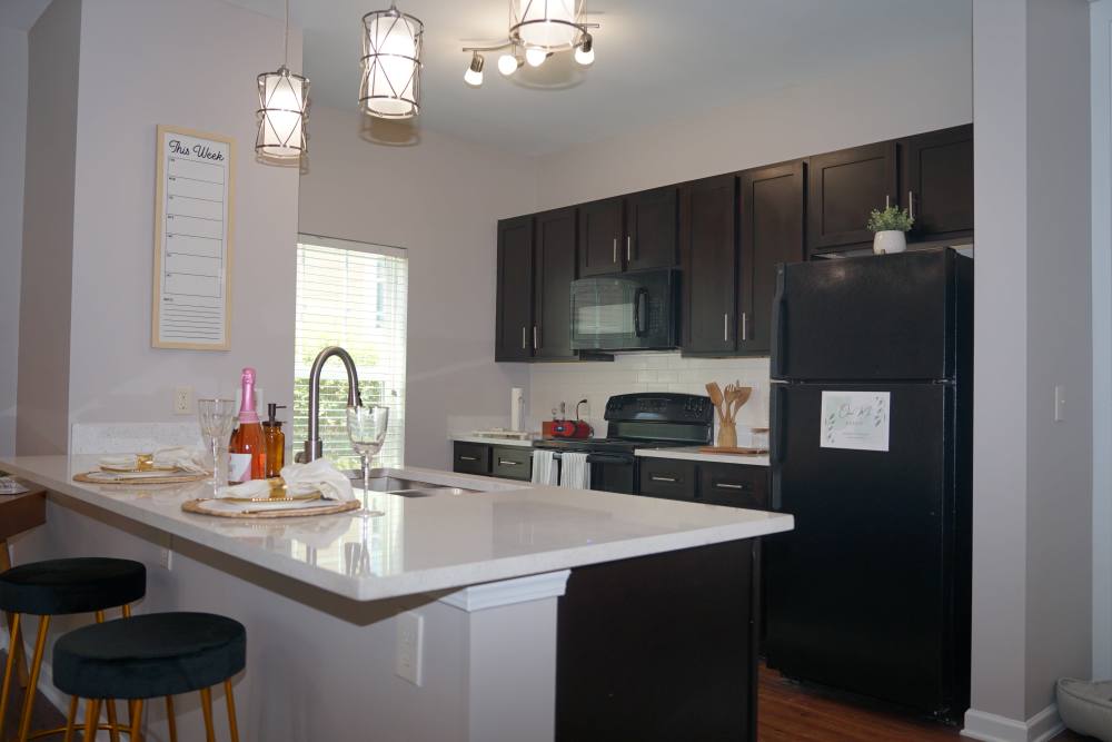 Kitchen with bar stool seating in a model home at Thomaston Crossing in Macon, Georgia