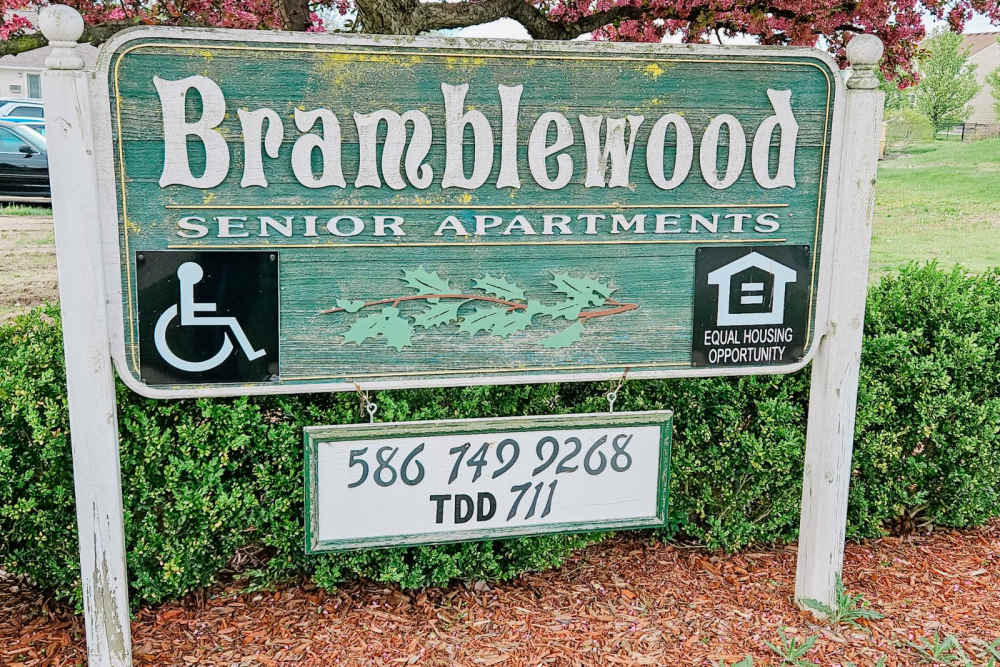 Front entrance sign of community grass and walking paths at Bramblewood in New Haven, Michigan