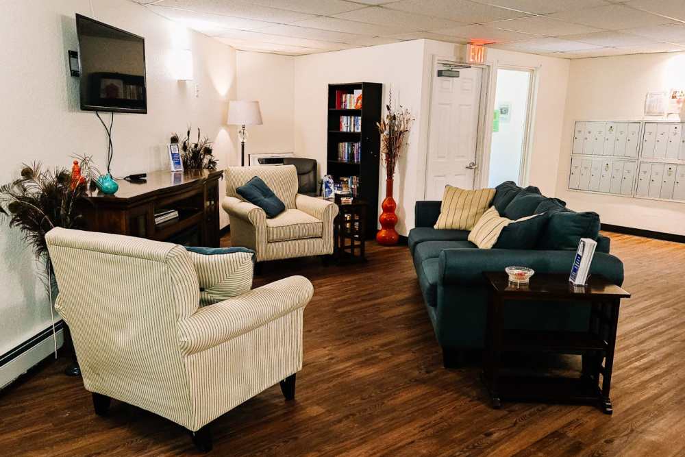 Resident seating area with large couches at entrance of Bramblewood in New Haven, Michigan